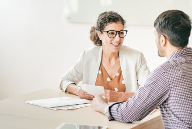 une femme et un homme discutent autour d'une table